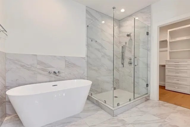 a spacious bathroom with a shower sink and mirror