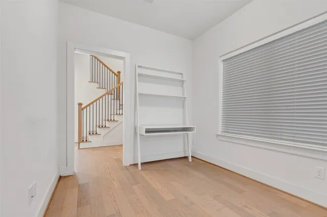 a kitchen with cabinets and chairs
