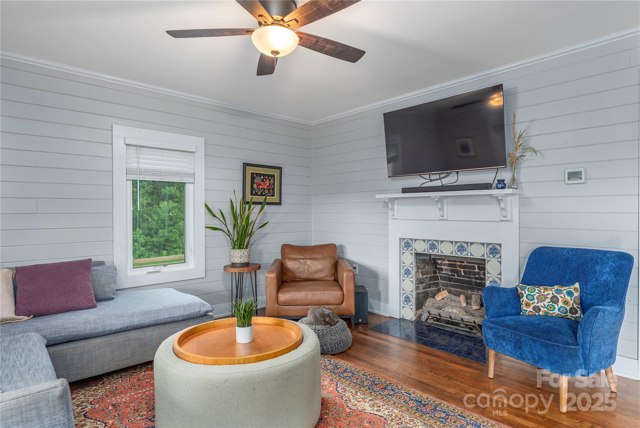 1304 Souther Road Old Fort, NC 28762 - Photo 13 of 48 a living room with furniture a fireplace and a flat screen tv