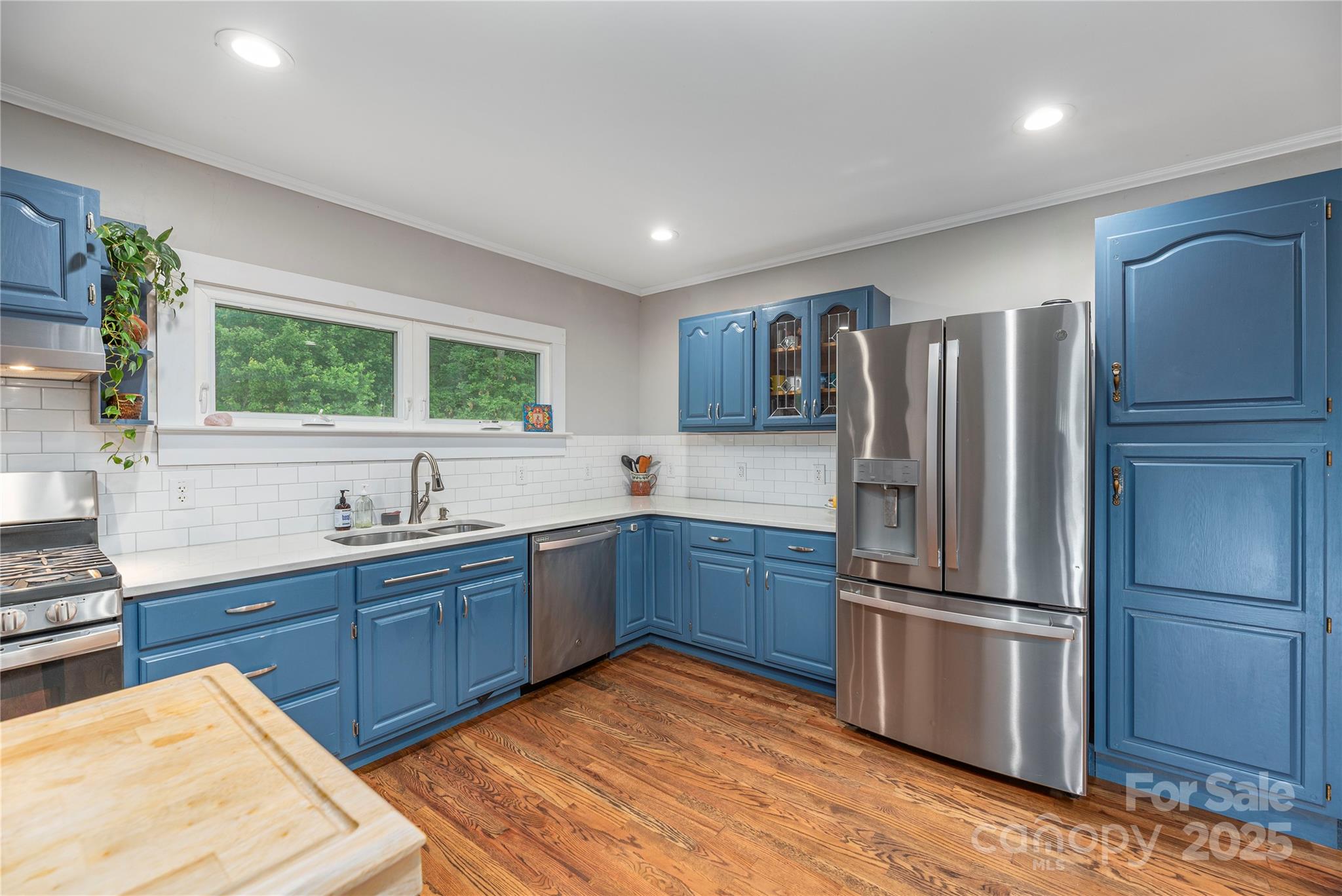1304 Souther Road Old Fort, NC 28762 - Photo 17 of 48 a kitchen with stainless steel appliances granite countertop a refrigerator sink and wooden floor