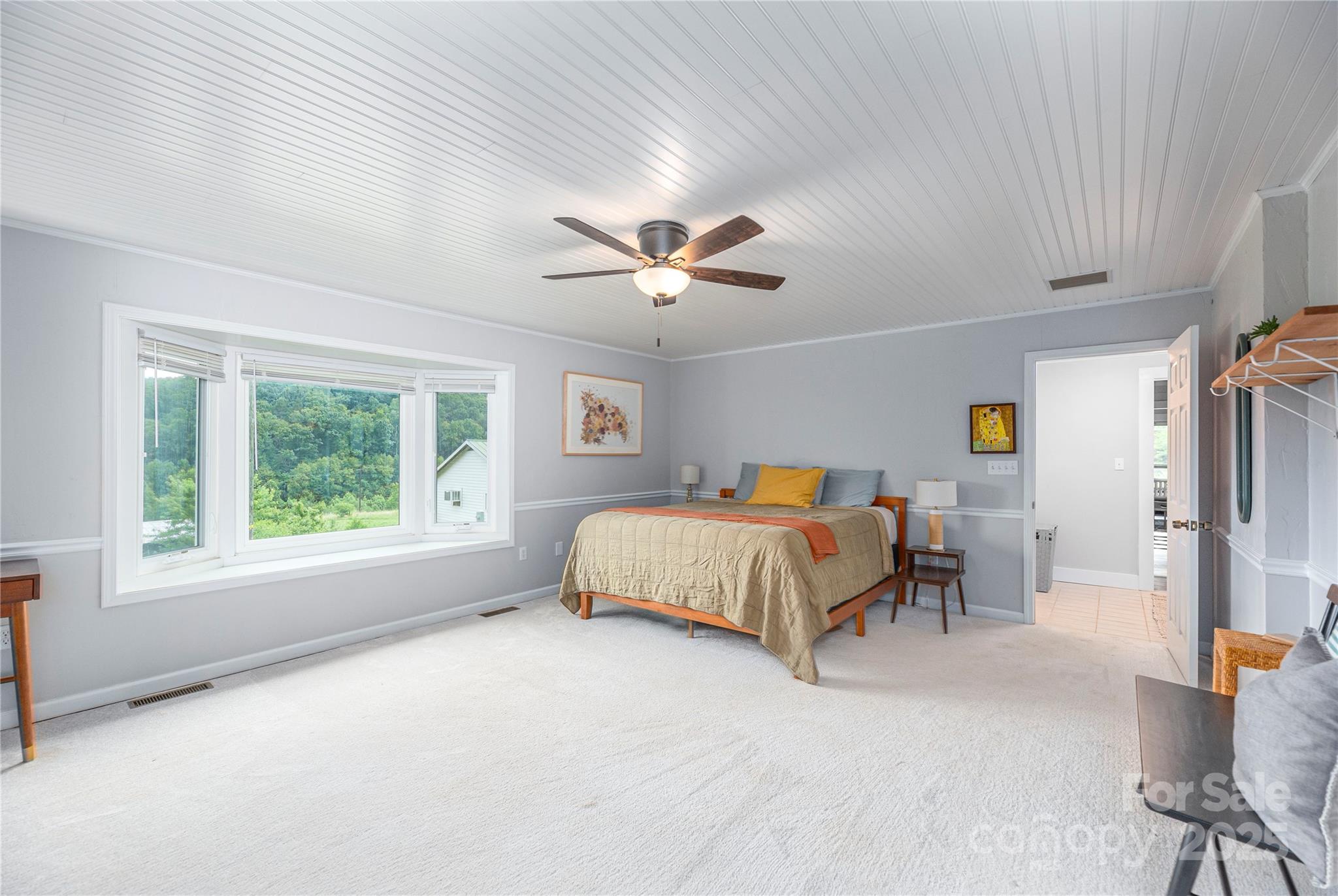 1304 Souther Road Old Fort, NC 28762 - Photo 21 of 48 a spacious bedroom with a bed a window and a ceiling fan