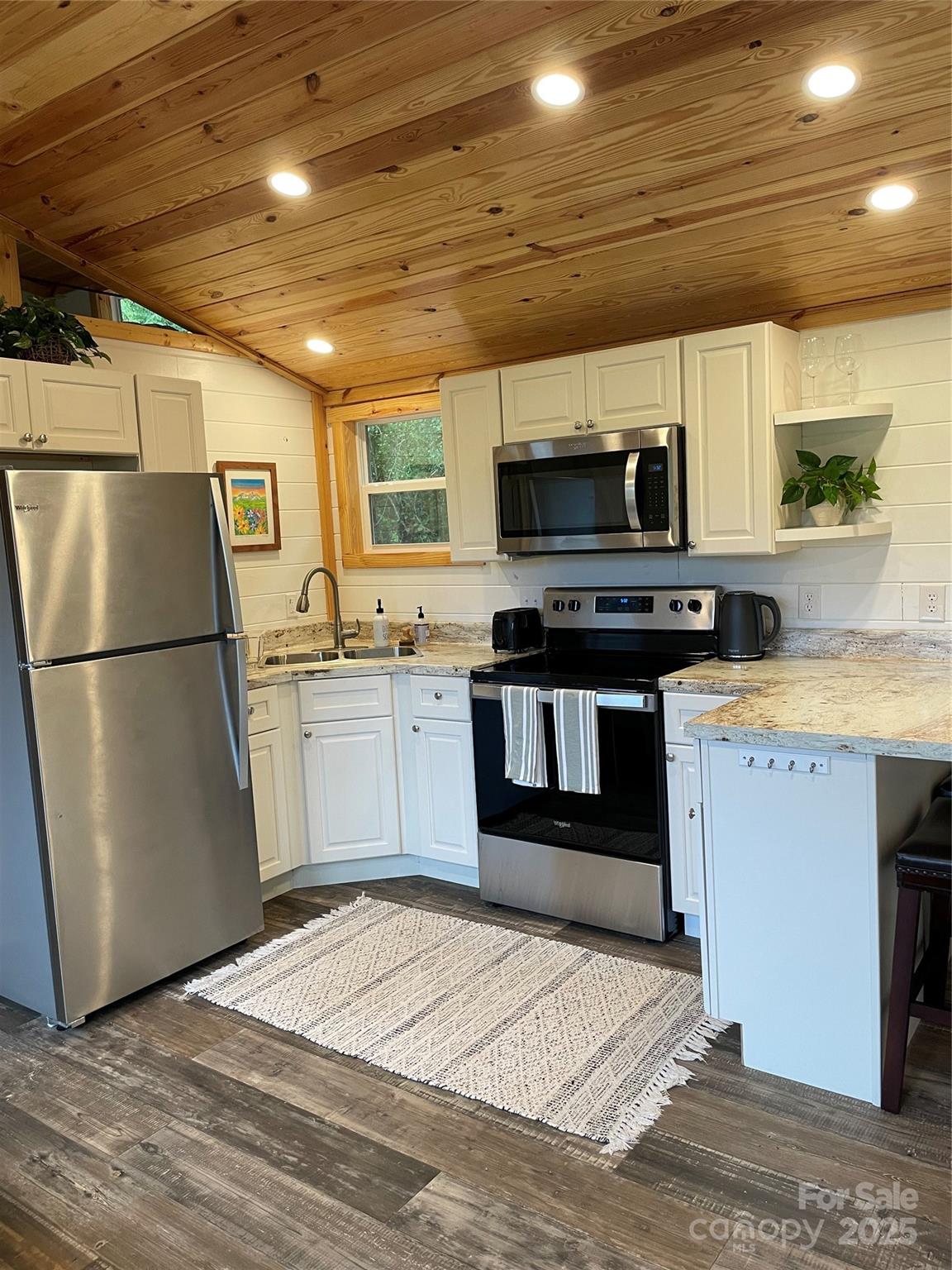 1304 Souther Road Old Fort, NC 28762 - Photo 38 of 48 a kitchen with a refrigerator and a stove top oven