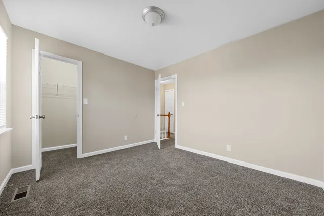 an empty room with closet area