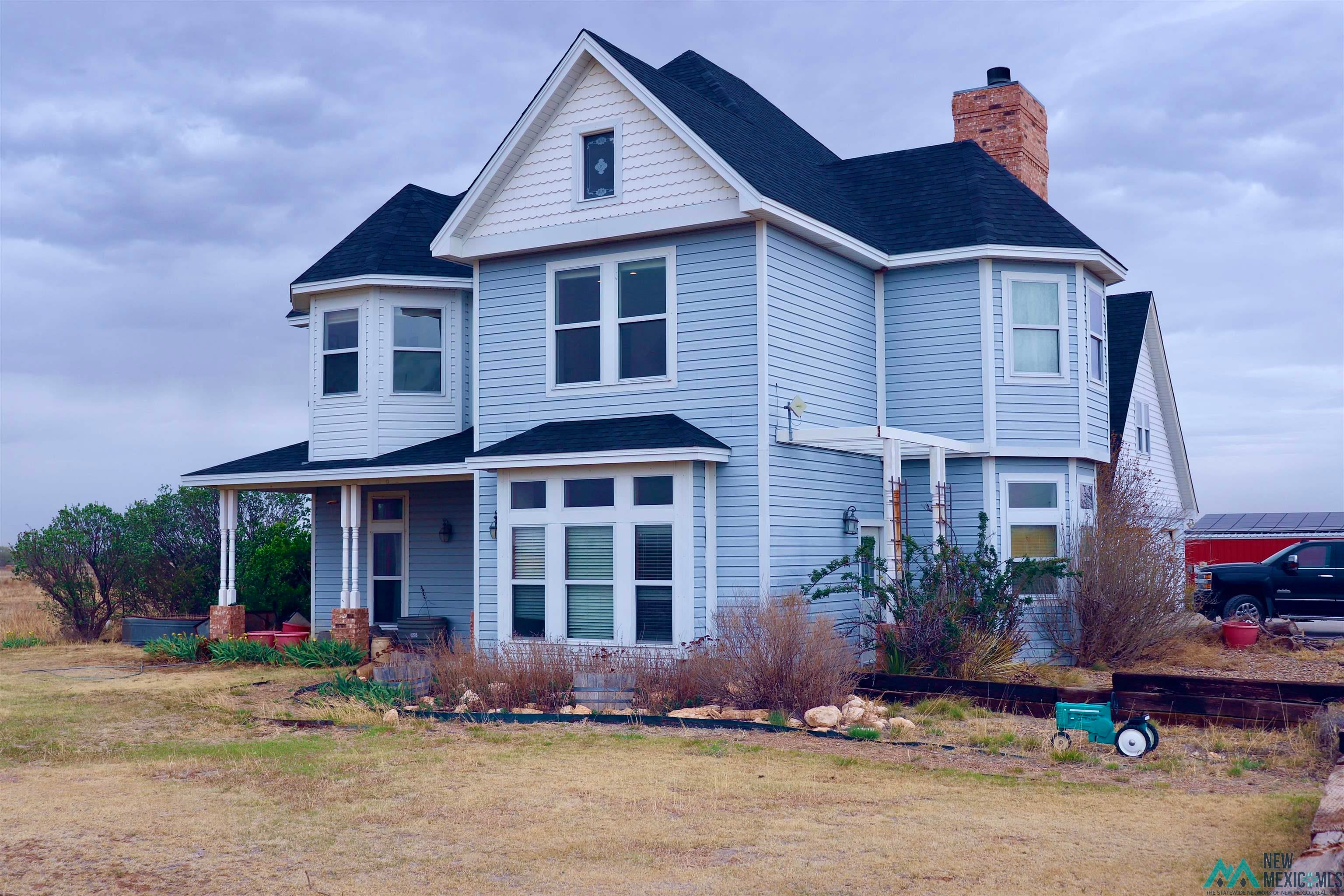 845 South Roosevelt Road South Portales, NM 88130 - Photo 1 of 47 Victorian-style house with roof with shingles, a chimney, and a front lawn
