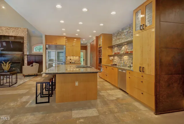 a living room with furniture and large windows