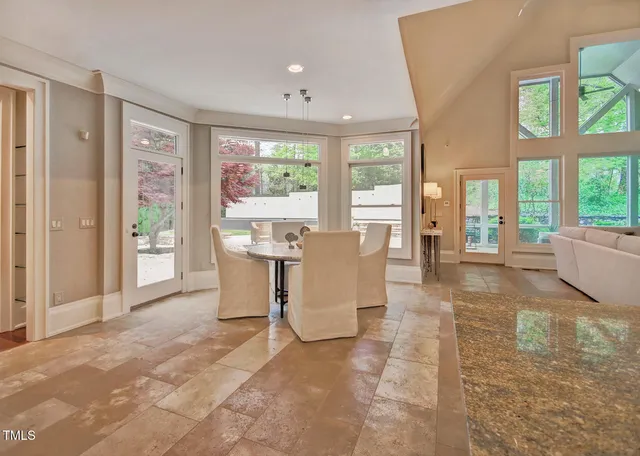 a living room with stainless steel appliances kitchen island granite countertop furniture and a view of kitchen