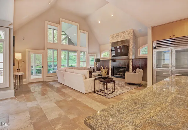 a patio with a table and chairs under an umbrella