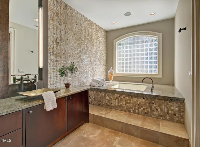 a bathroom with a sink and a window