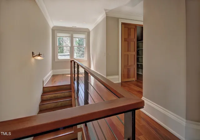 an empty room with windows and ceiling fan