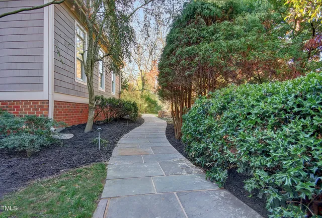 a view of a pathway with a house in the background