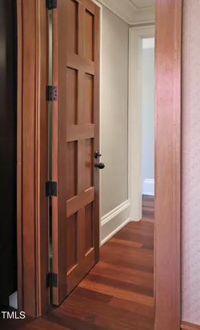 a view of an empty room and wooden floor