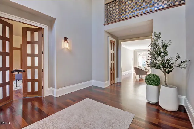 a living room with furniture and large windows