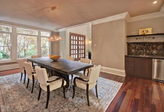 a dining room with furniture and wooden floor