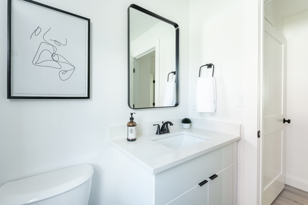 7 Kenoza Avenue, Unit 101 Haverhill, MA 01830 - Photo 11 of 21 a bathroom with a sink and a mirror
