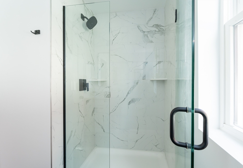 7 Kenoza Avenue, Unit 101 Haverhill, MA 01830 - Photo 13 of 21 a bathroom with a shower