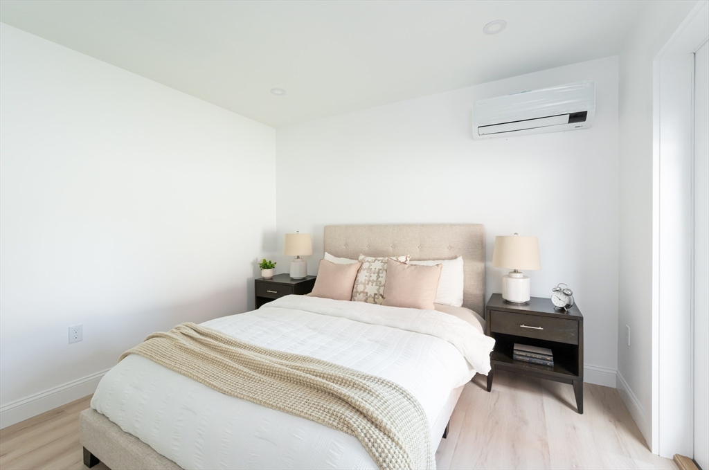 7 Kenoza Avenue, Unit 101 Haverhill, MA 01830 - Photo 16 of 21 a bedroom with a bed and a night stand