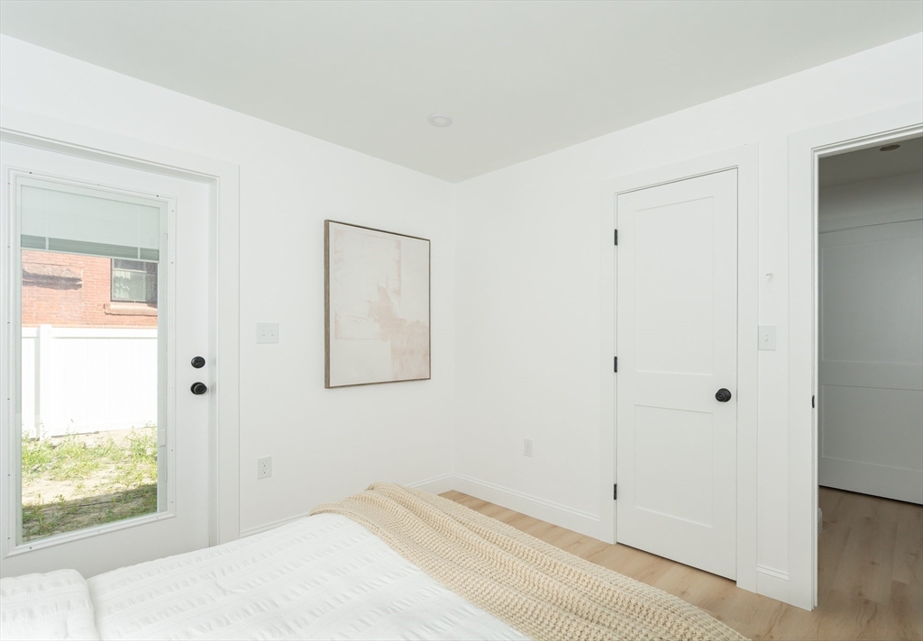 7 Kenoza Avenue, Unit 101 Haverhill, MA 01830 - Photo 17 of 21 a bedroom with a bed and a window