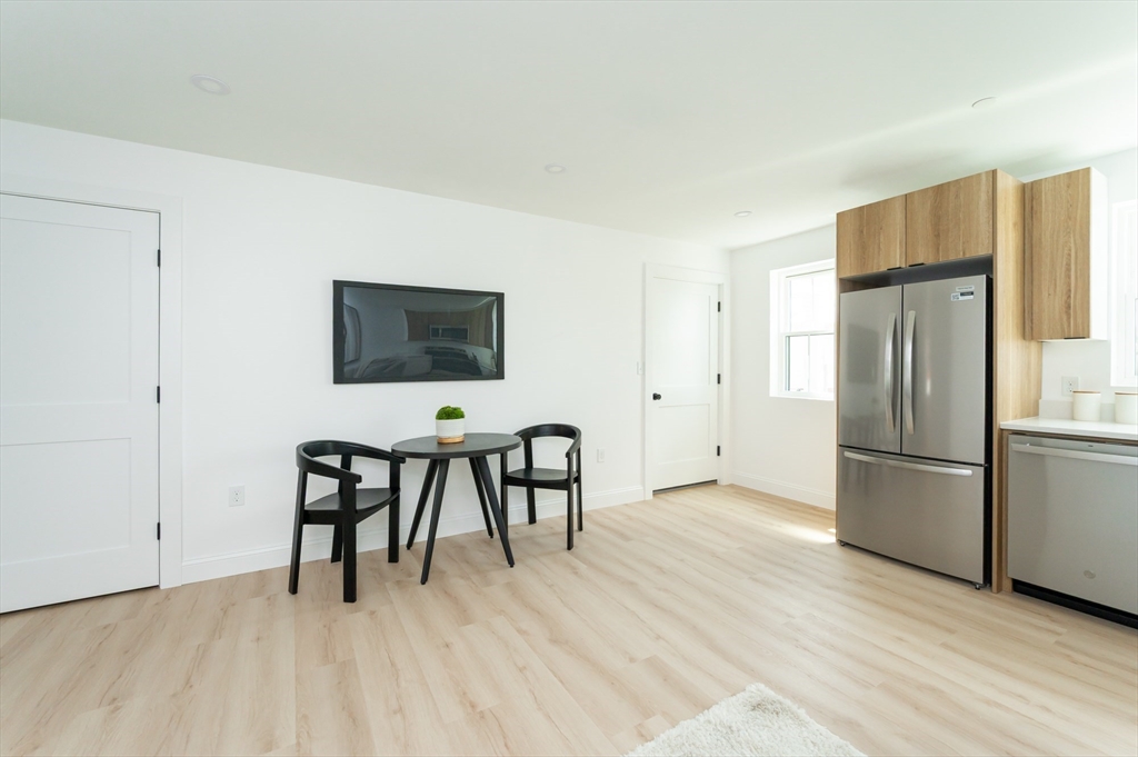 7 Kenoza Avenue, Unit 101 Haverhill, MA 01830 - Photo 8 of 21 a view of a livingroom with furniture and a kitchen