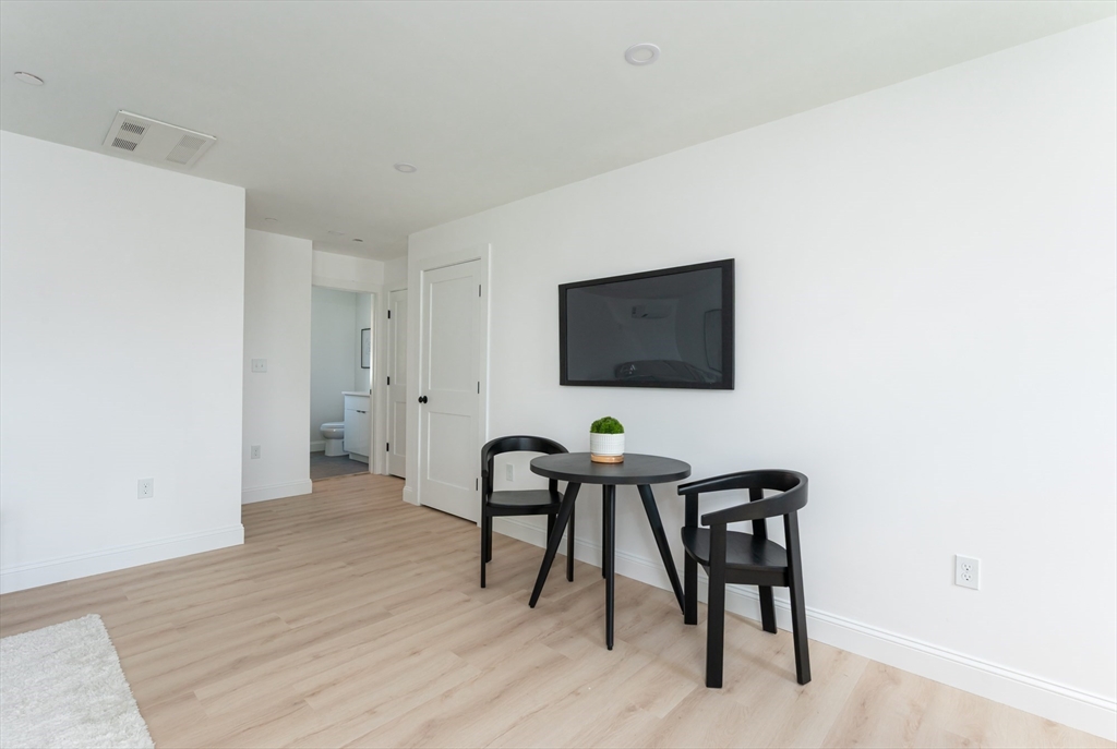 7 Kenoza Avenue, Unit 101 Haverhill, MA 01830 - Photo 9 of 21 a view of a workspace with furniture and wooden floor
