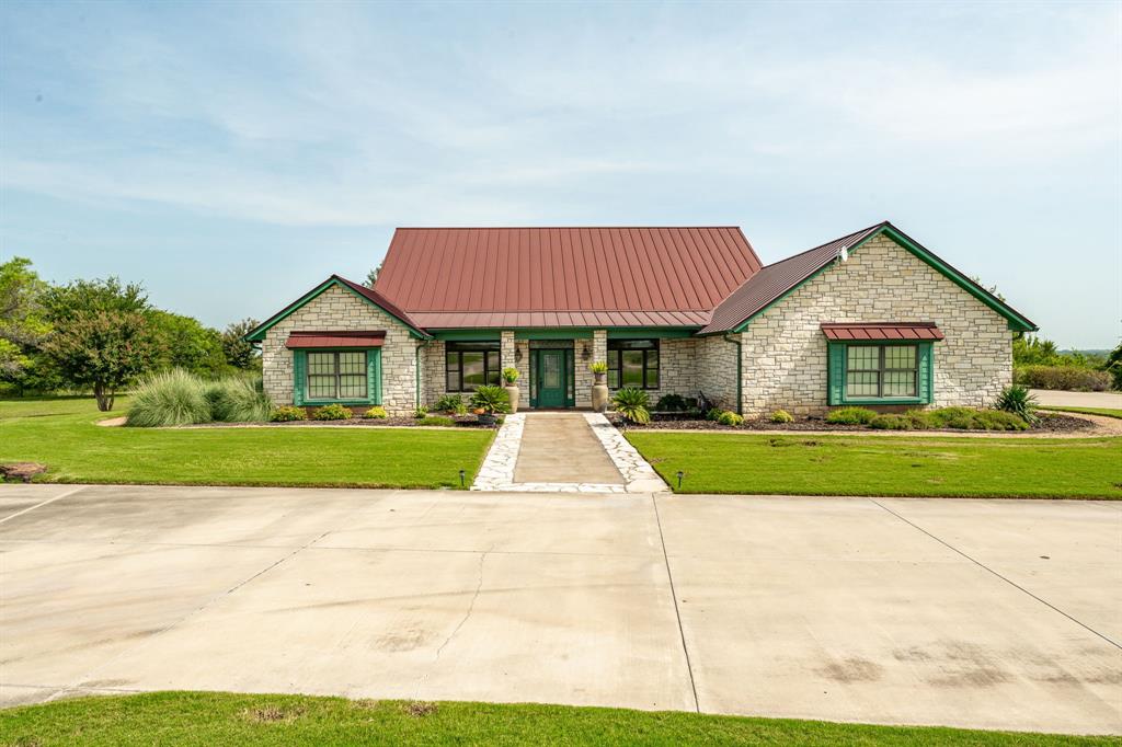 501 County Road 103, Unit 1 Comanche, TX 76442 - Photo 2 of 38 a front view of house with yard and green space