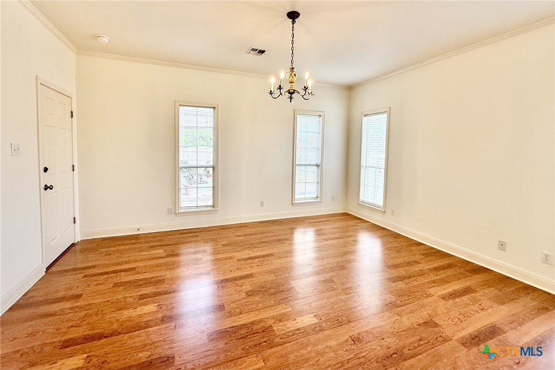 415 South Trinity Street Edna, TX 77957 - Photo 21 of 46 a view of empty room with wooden floor and fan