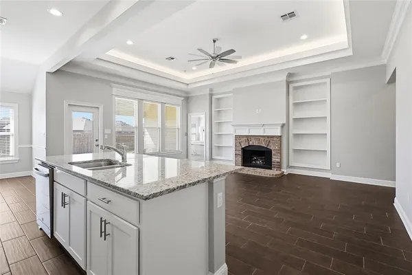 a kitchen with granite countertop a oven and a fireplace