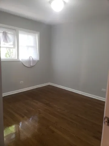 a view of wooden floor and windows in a room