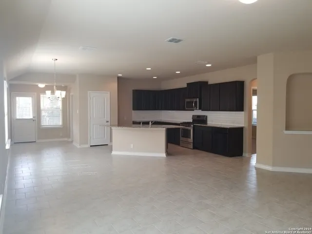 a view of kitchen with cabinets and wooden floor