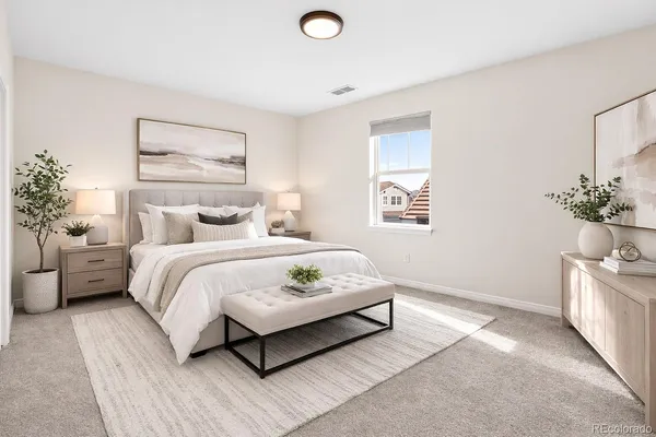 a bedroom with a bed and a potted plant