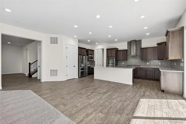 a view of kitchen with kitchen island a sink a center island stainless steel appliances and a cabinets