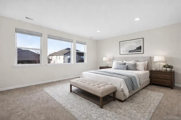 a spacious bedroom with a bed and window