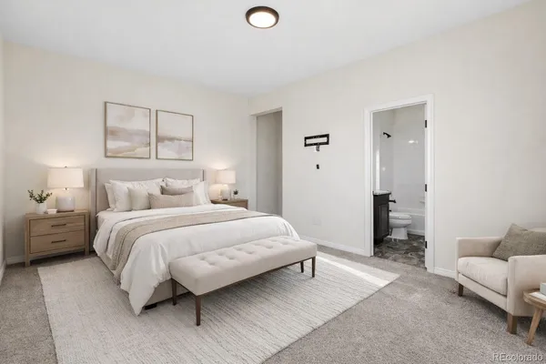 a bedroom with a bed and a couch