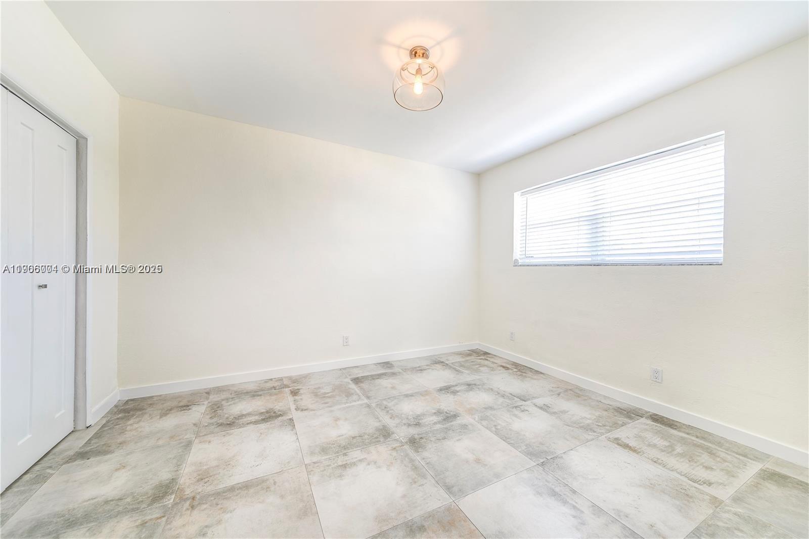7975 Crespi Boulevard, Unit 1 Miami Beach, FL 33141 - Photo 11 of 21 a view of an empty room with a window