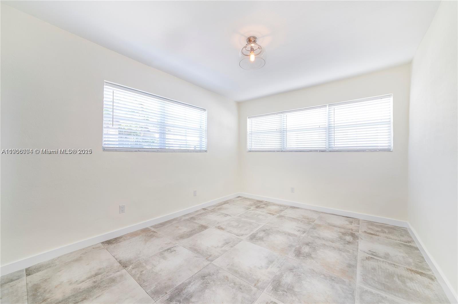 7975 Crespi Boulevard, Unit 1 Miami Beach, FL 33141 - Photo 12 of 21 a view of an empty room with a window
