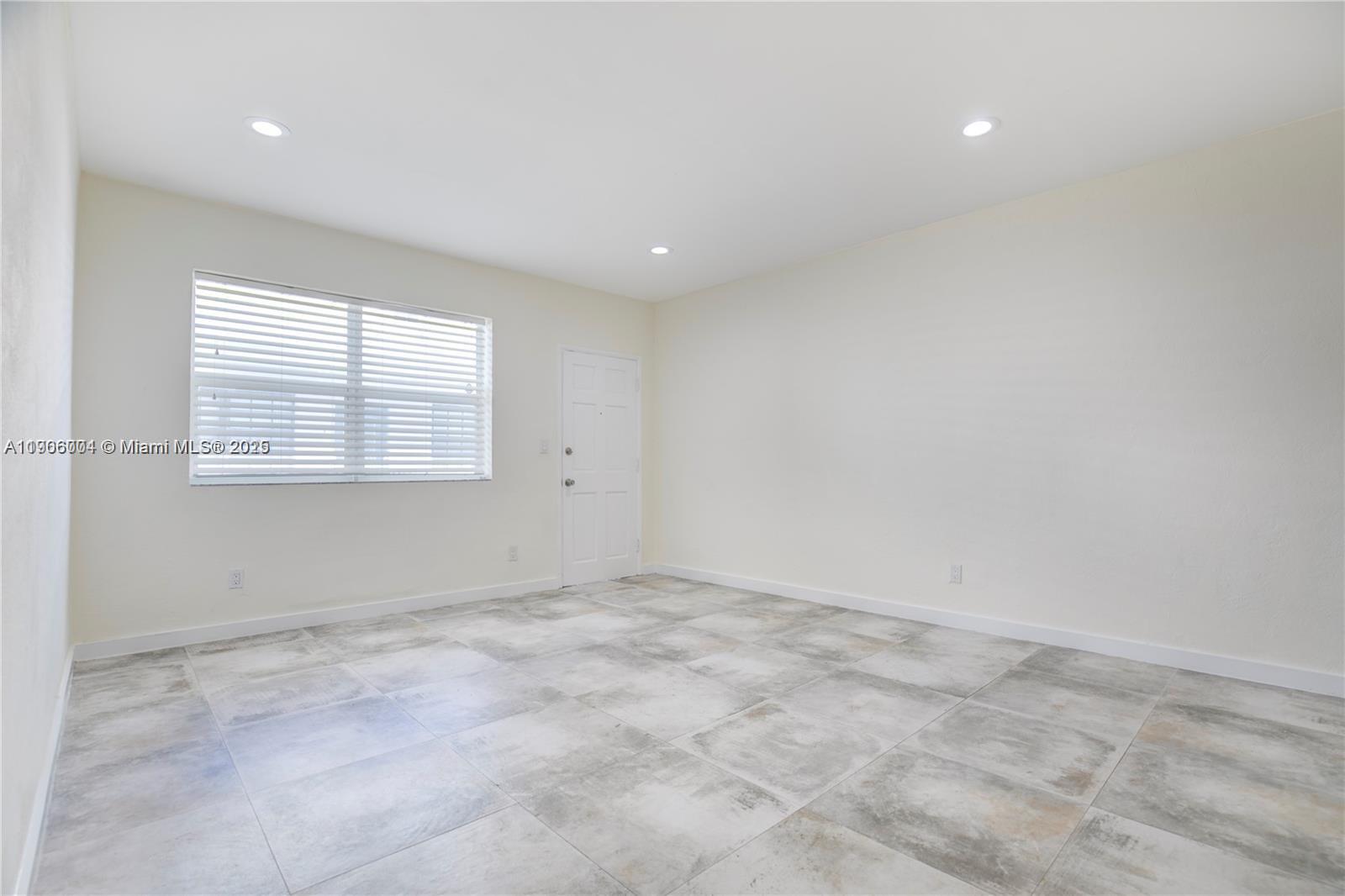7975 Crespi Boulevard, Unit 1 Miami Beach, FL 33141 - Photo 13 of 21 an empty room with windows