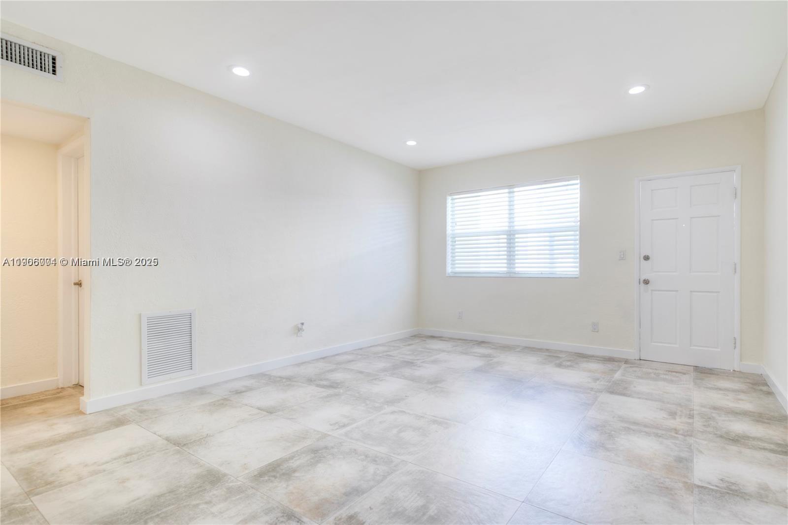 7975 Crespi Boulevard, Unit 1 Miami Beach, FL 33141 - Photo 10 of 21 an empty room with windows