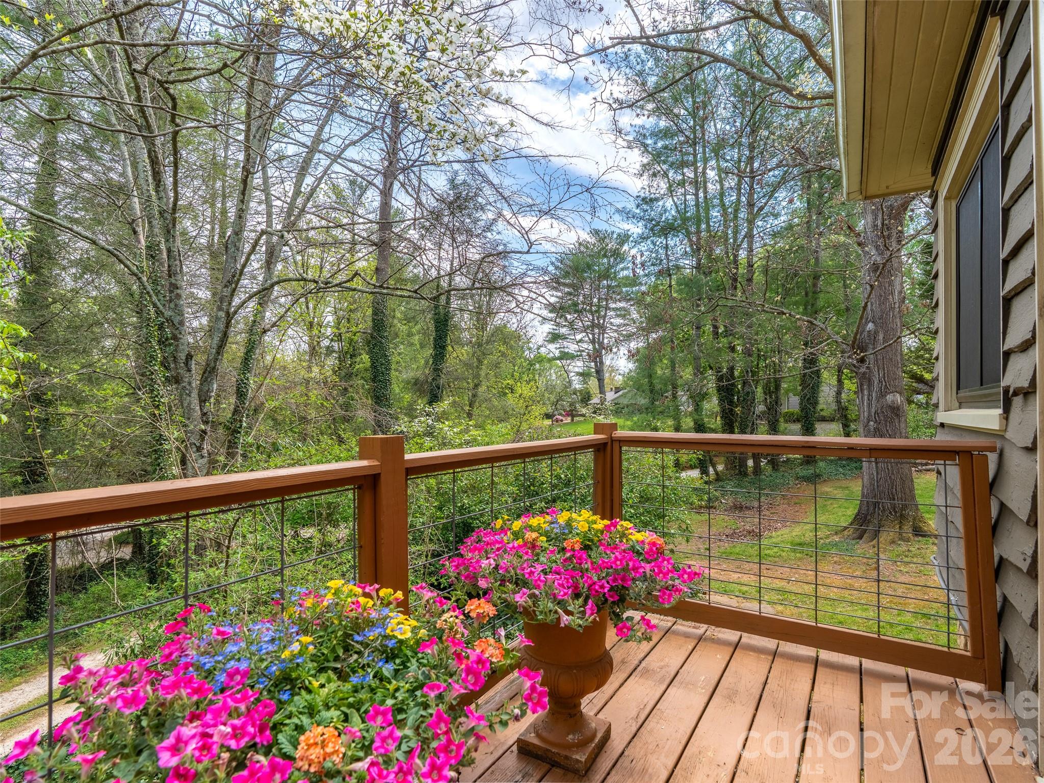 686 New Haw Creek Road Asheville, NC 28805 - Photo 11 of 47 a view of a balcony with flower plants