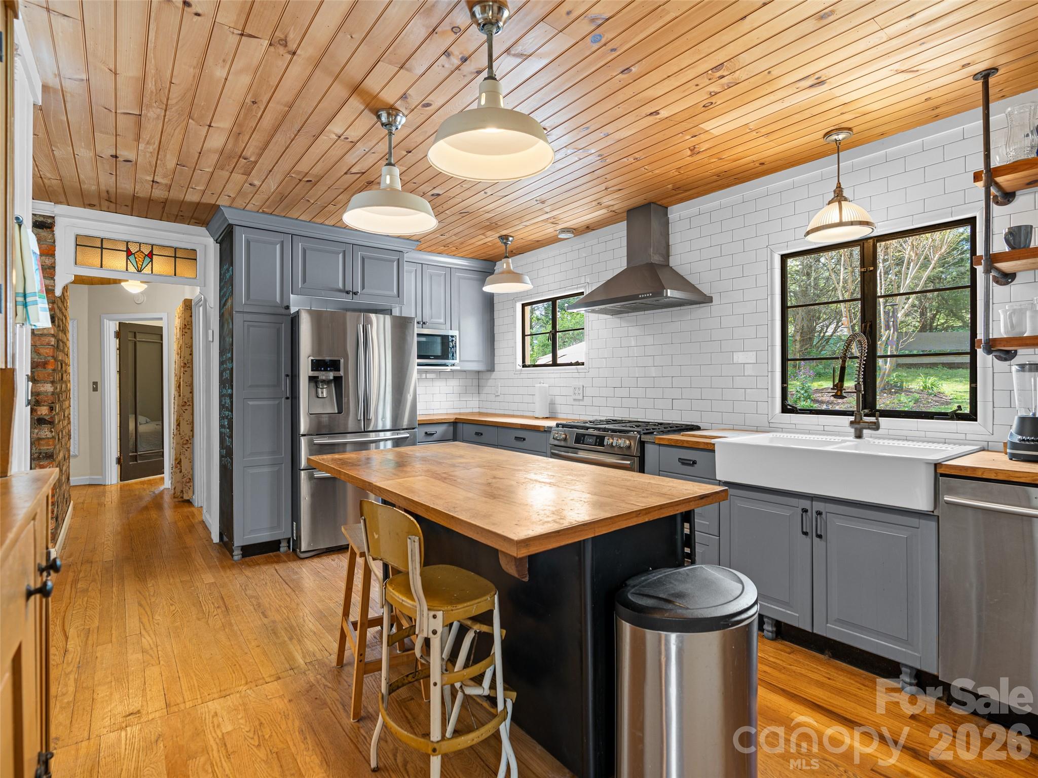 686 New Haw Creek Road Asheville, NC 28805 - Photo 15 of 47 a kitchen with stainless steel appliances granite countertop a sink and a refrigerator