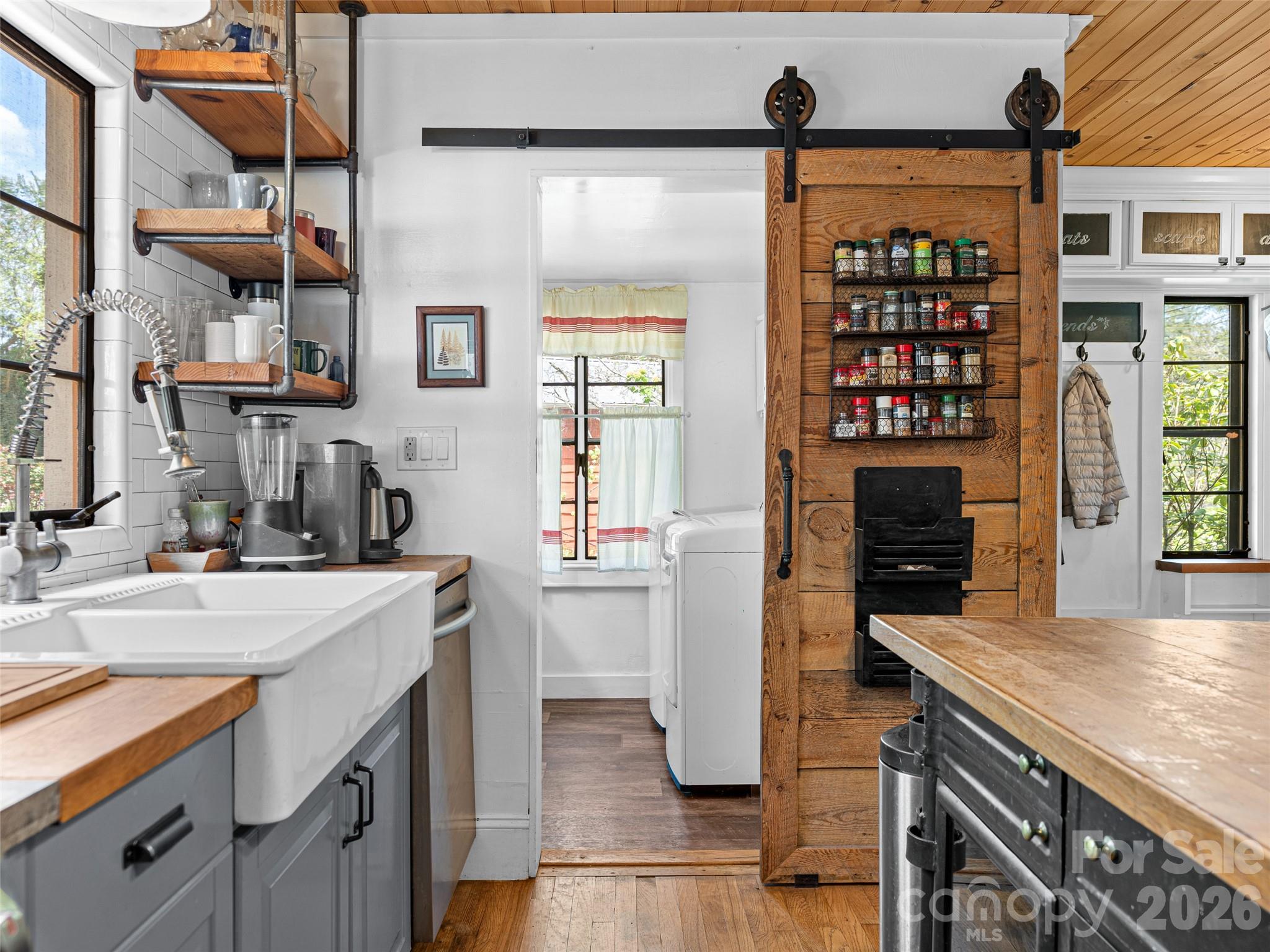 686 New Haw Creek Road Asheville, NC 28805 - Photo 21 of 47 a kitchen with a sink and a refrigerator
