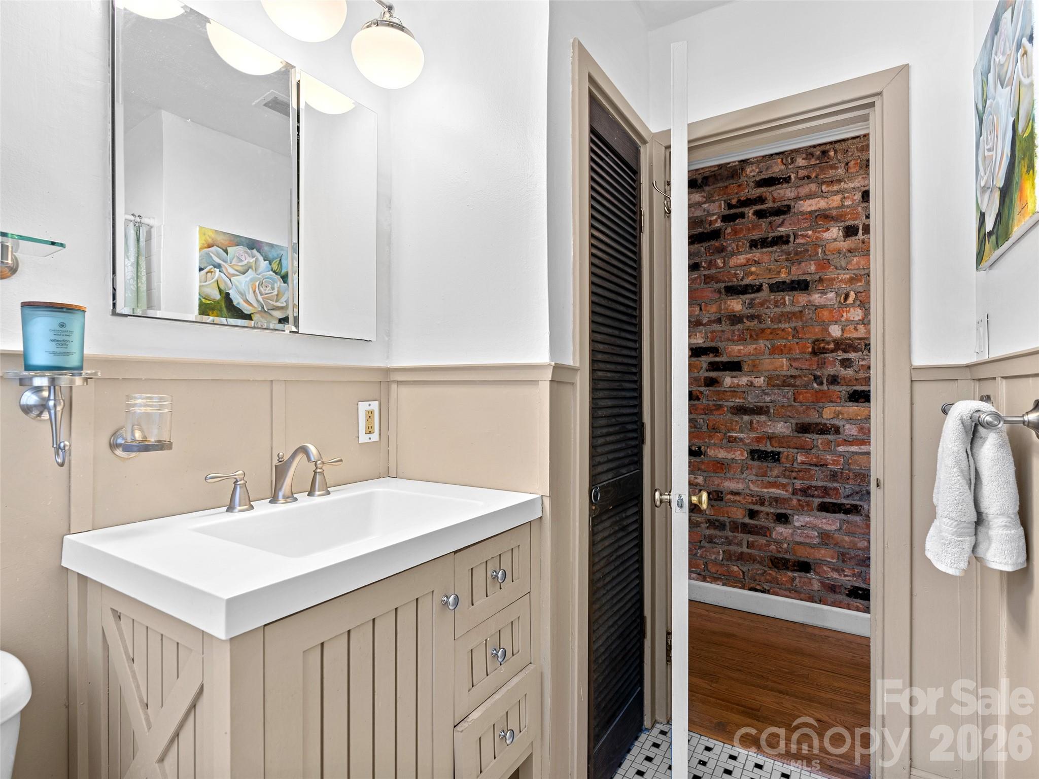 686 New Haw Creek Road Asheville, NC 28805 - Photo 24 of 47 a bathroom with a sink a mirror and a shower