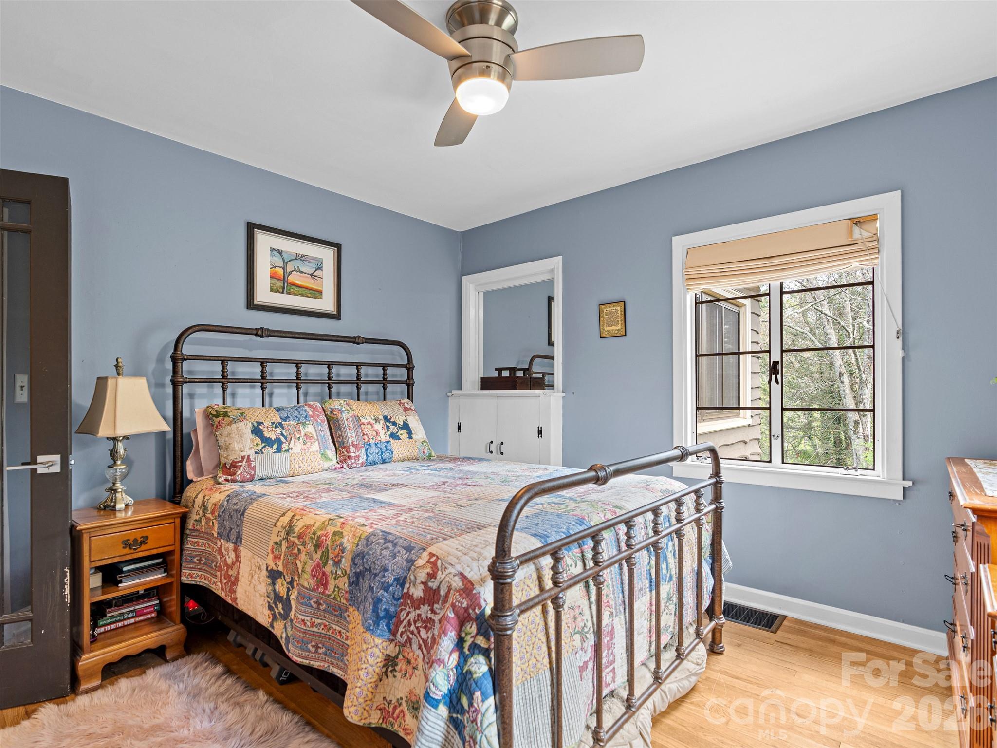 686 New Haw Creek Road Asheville, NC 28805 - Photo 27 of 47 a bedroom with a bed and a window