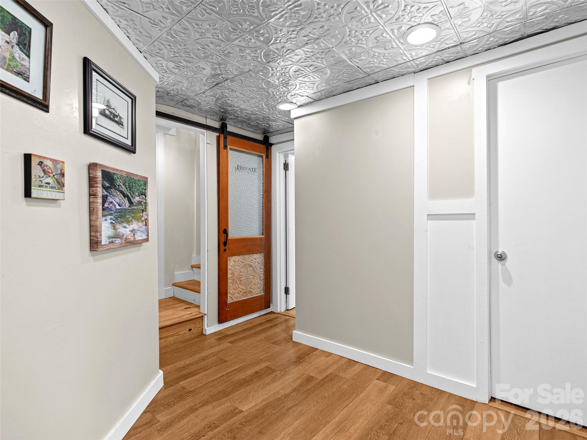 686 New Haw Creek Road Asheville, NC 28805 - Photo 33 of 47 a view of a hallway with wooden floor and closet