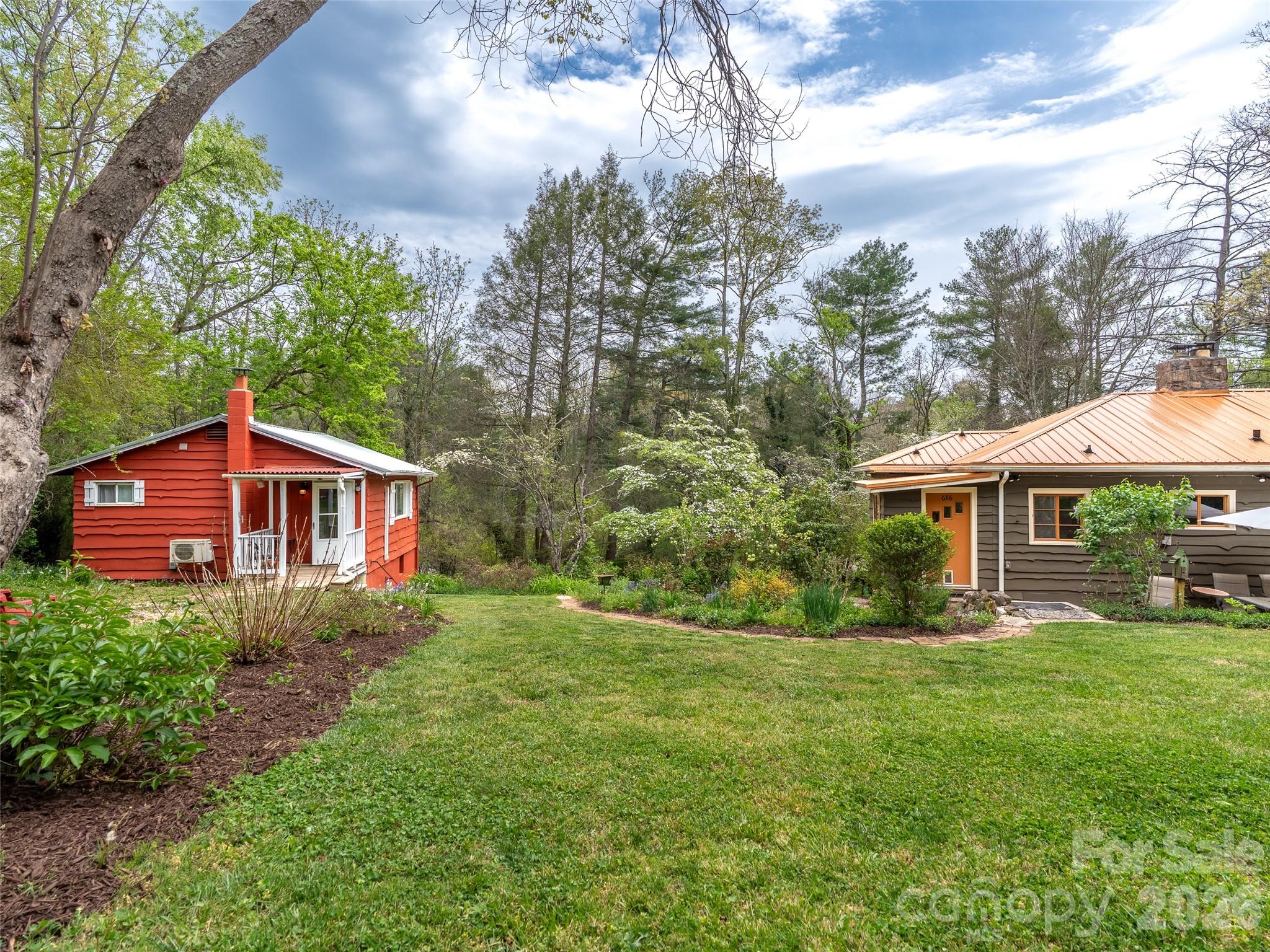 686 New Haw Creek Road Asheville, NC 28805 - Photo 38 of 47 a front view of a house with garden