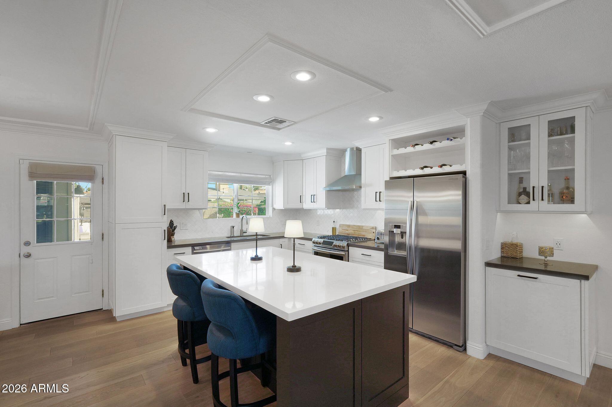 5019 North 2nd Street Phoenix, AZ 85012 - Photo 11 of 30 a kitchen with refrigerator and chairs