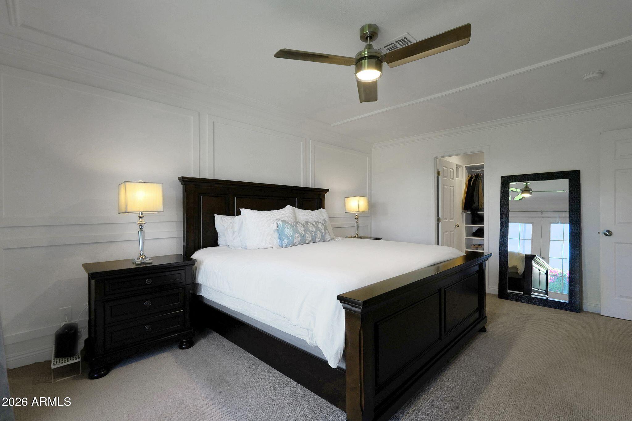 5019 North 2nd Street Phoenix, AZ 85012 - Photo 16 of 30 a bedroom with a bed and a ceiling fan