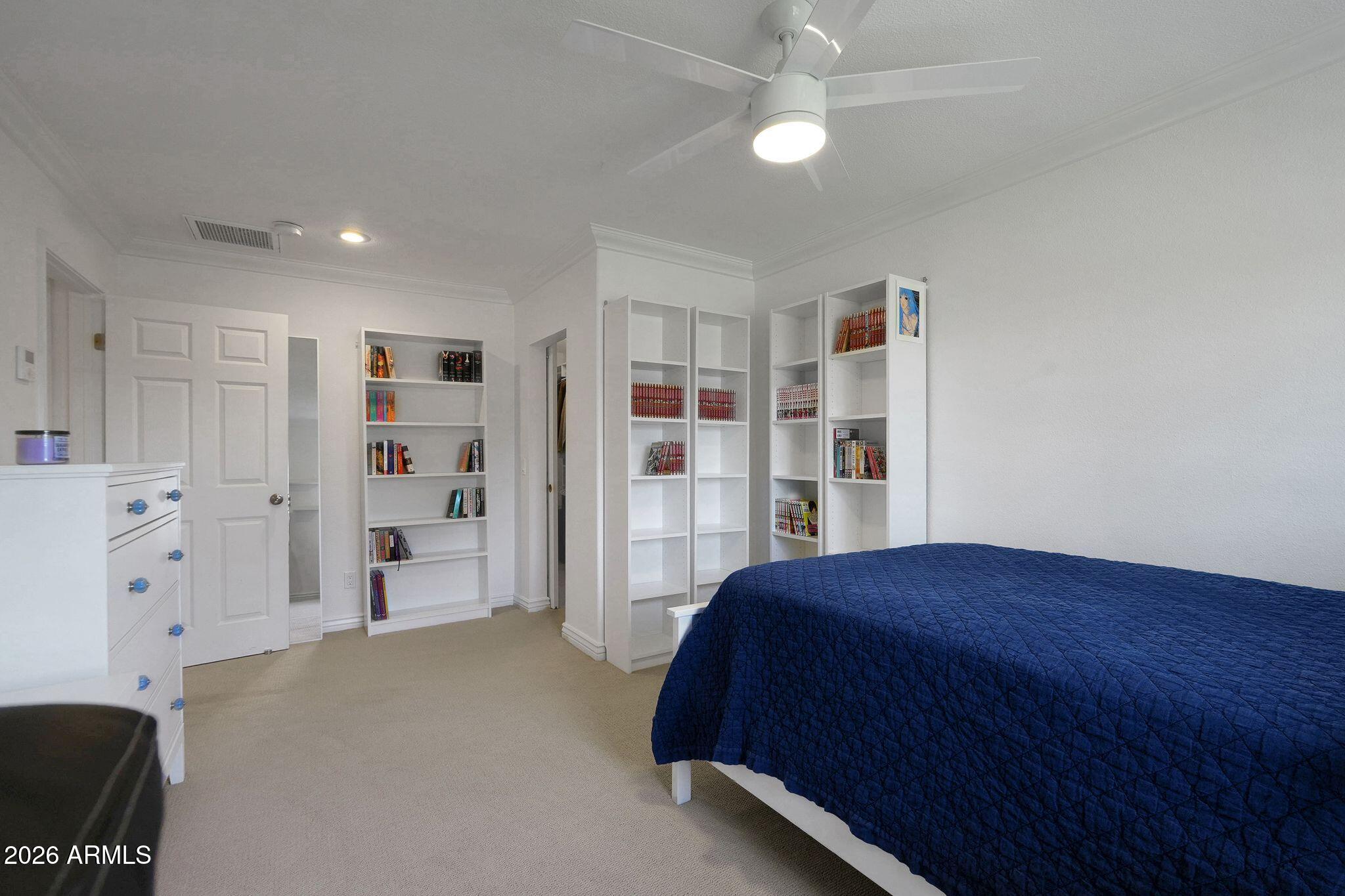 5019 North 2nd Street Phoenix, AZ 85012 - Photo 19 of 30 a bedroom with a large bed and a book shelf