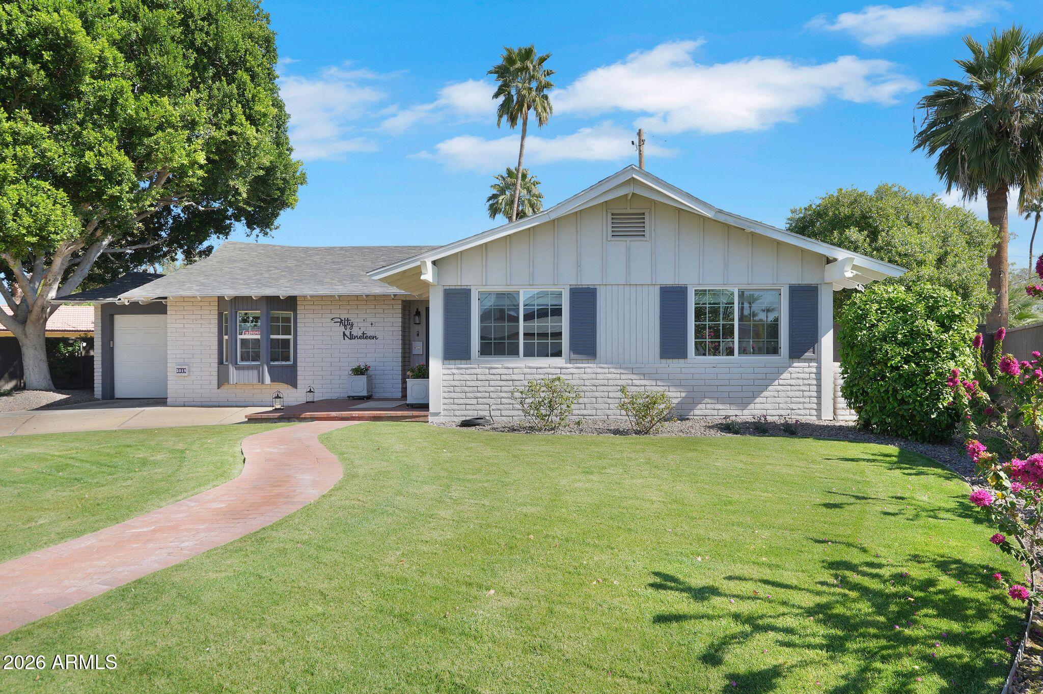 5019 North 2nd Street Phoenix, AZ 85012 - Photo 2 of 30 a view of a house with a yard and a large tree