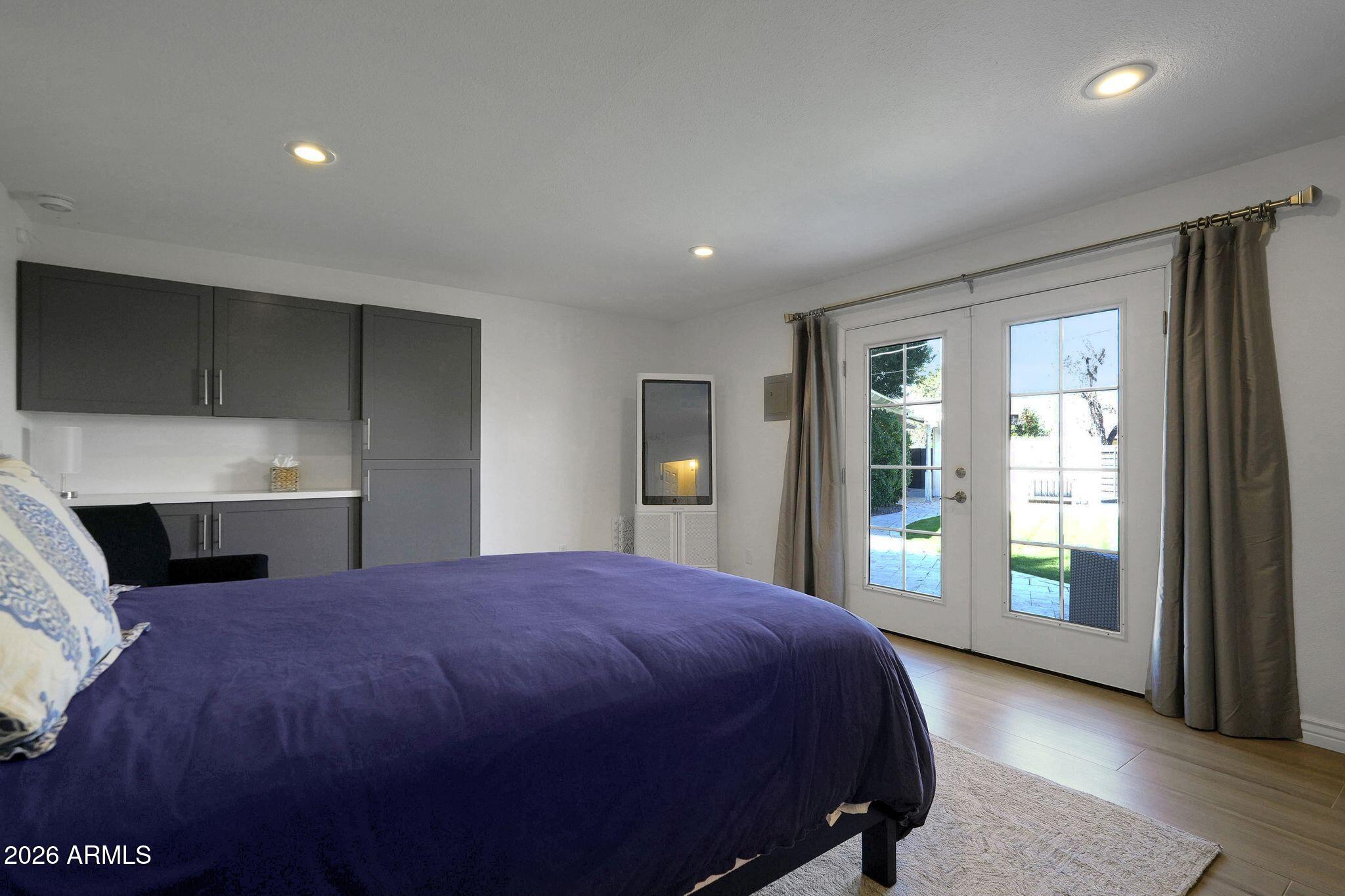 5019 North 2nd Street Phoenix, AZ 85012 - Photo 24 of 30 a spacious bedroom with a large bed and a dresser