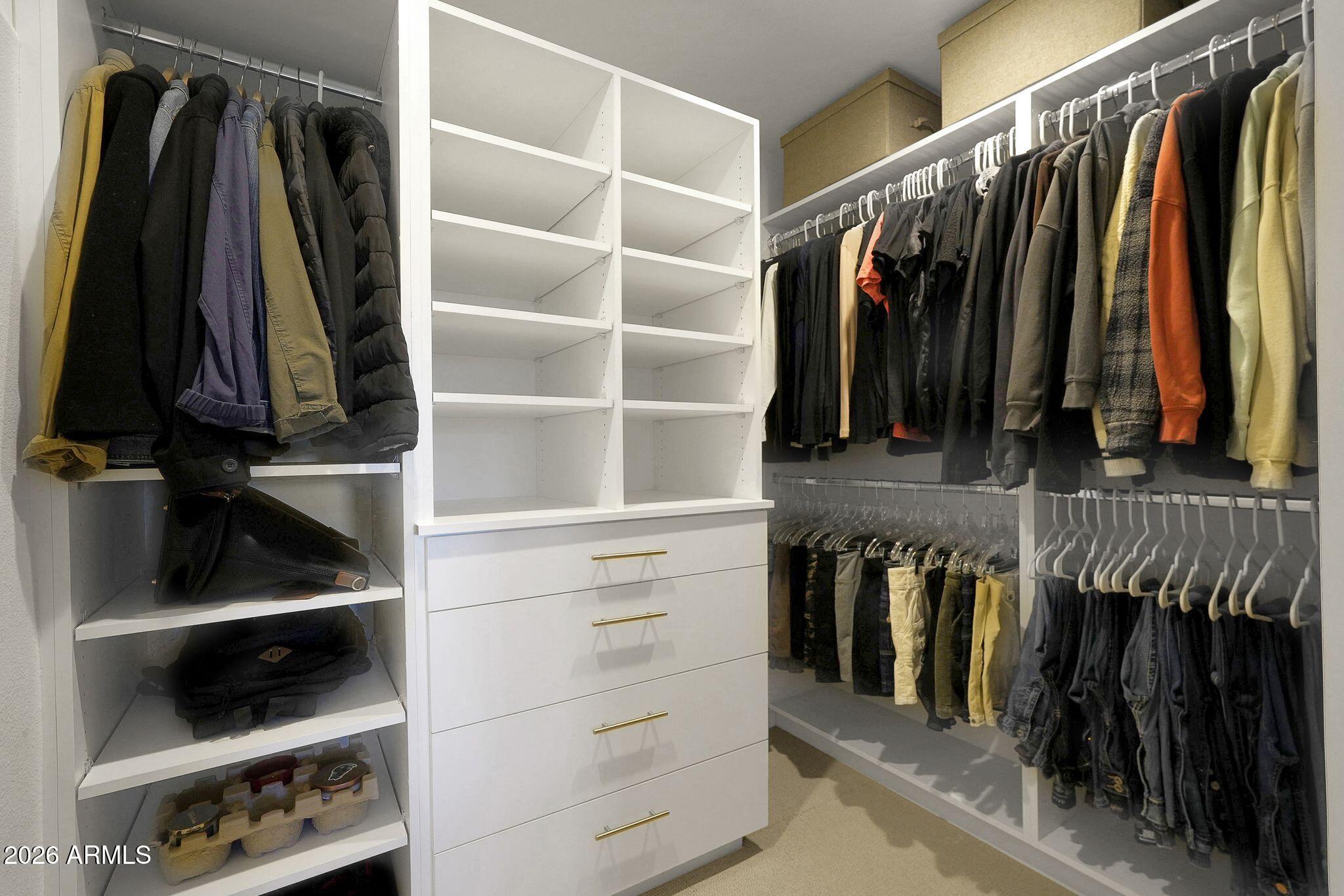 5019 North 2nd Street Phoenix, AZ 85012 - Photo 25 of 30 a view of walk in closet with clothes and shoes