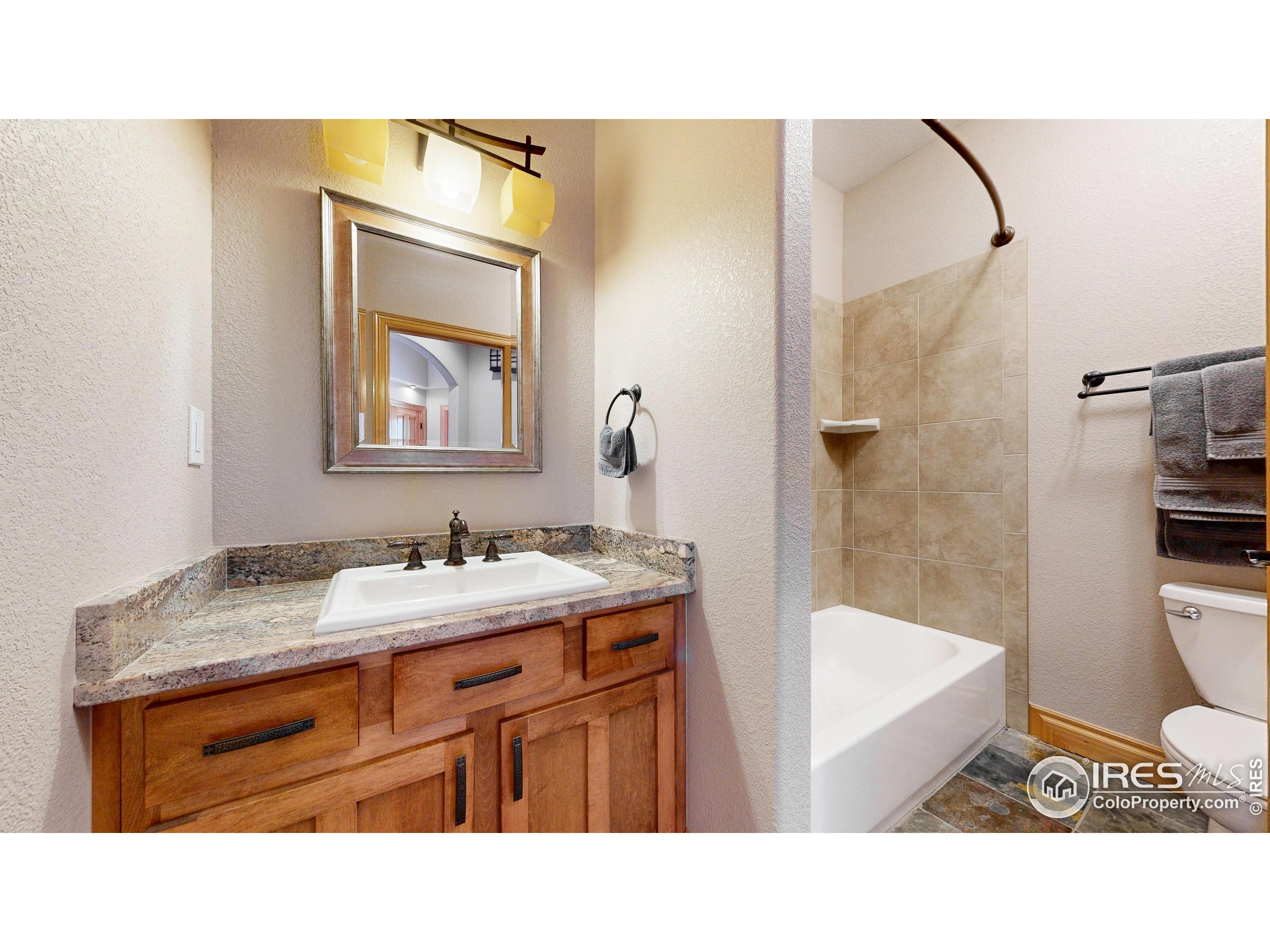 3602 Doral Place Longmont, CO 80503 - Photo 20 of 40 a bathroom with a sink a toilet and shower